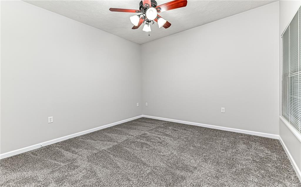 1012 Stockton Ridge Cranberry Township, PA 16066 - Photo 22 of 32 an empty room with a chandelier fan and wooden floor