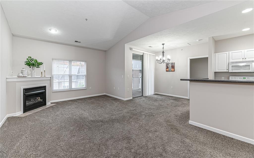 1012 Stockton Ridge Cranberry Township, PA 16066 - Photo 5 of 32 a view of a kitchen and a room with a fireplace