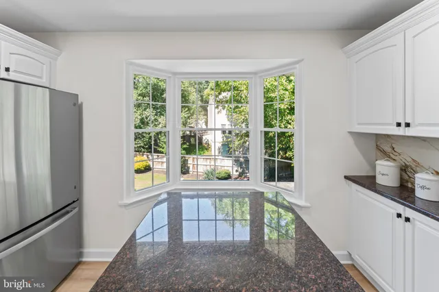 a kitchen with kitchen island granite countertop stainless steel appliances a stove a sink a refrigerator a microwave a cabinets and a center island