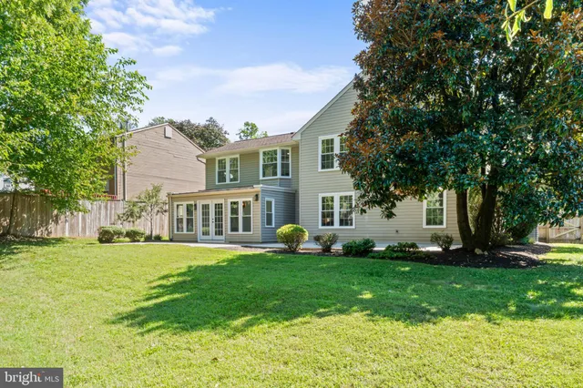 a house view with swimming pool in front of it
