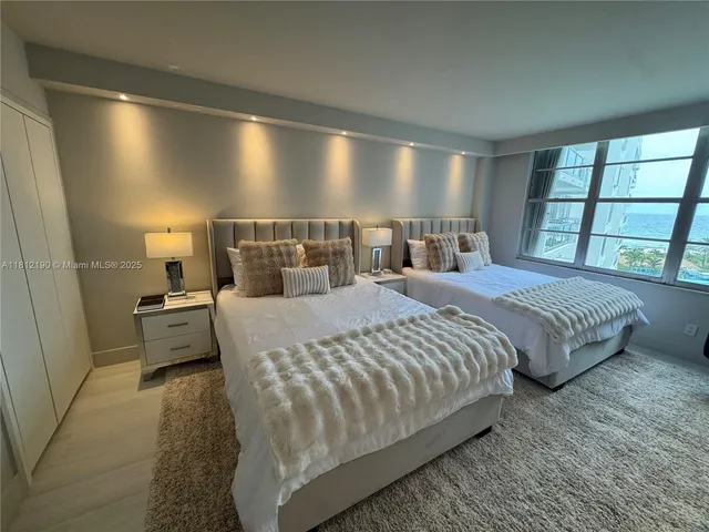 a bed room with a bed and large window