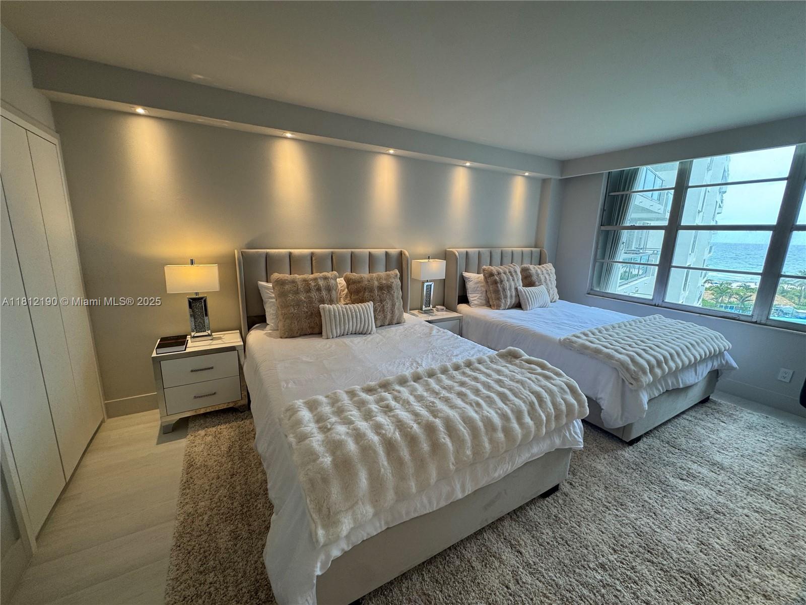 5151 Collins Avenue, Unit 726 Miami Beach, FL 33140 - Photo 14 of 32 a bed room with a bed and large window