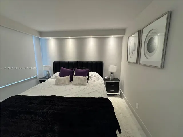 a bedroom with a bed and cabinets