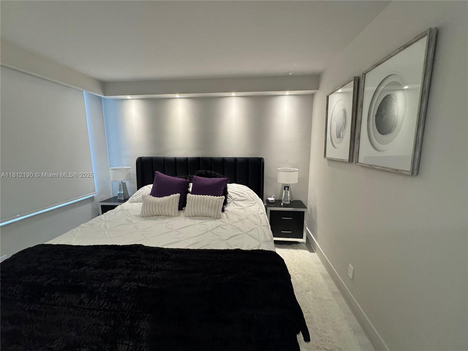 5151 Collins Avenue, Unit 726 Miami Beach, FL 33140 - Photo 17 of 32 a bedroom with a bed and cabinets