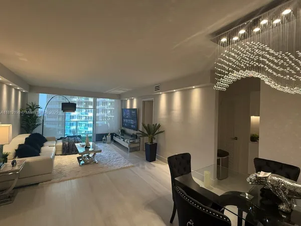 a living room with furniture and large windows