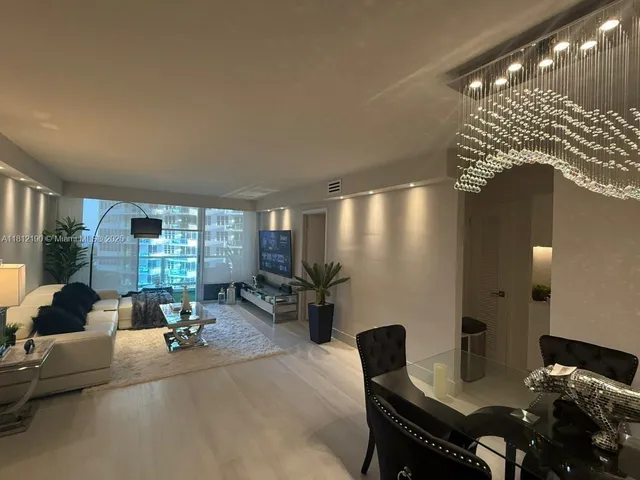 a living room with furniture and large windows