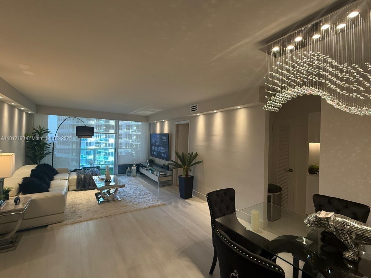 5151 Collins Avenue, Unit 726 Miami Beach, FL 33140 - Photo 6 of 32 a living room with furniture and large windows