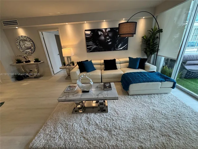 a living room with furniture and a mirror