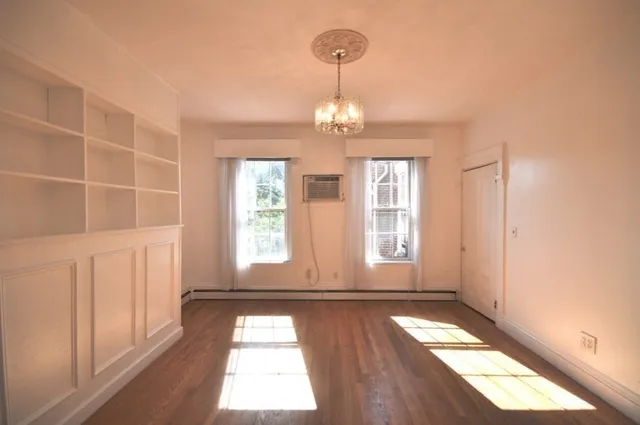 a view of entryway with wooden floor and window