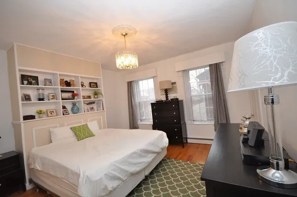 a bed room with a bed window and table