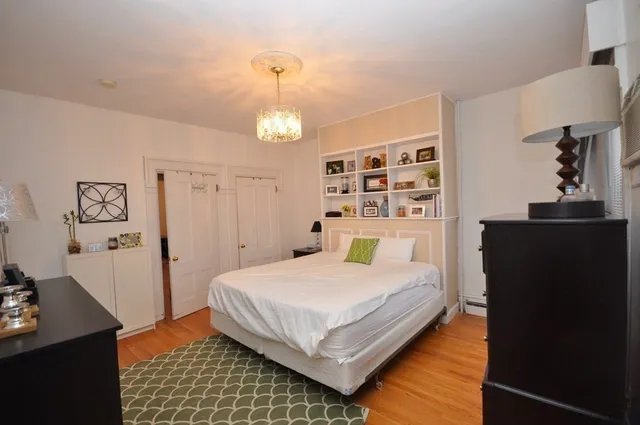 a bedroom with a bed and a dresser