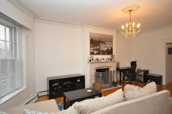 a living room with furniture a fireplace and a window