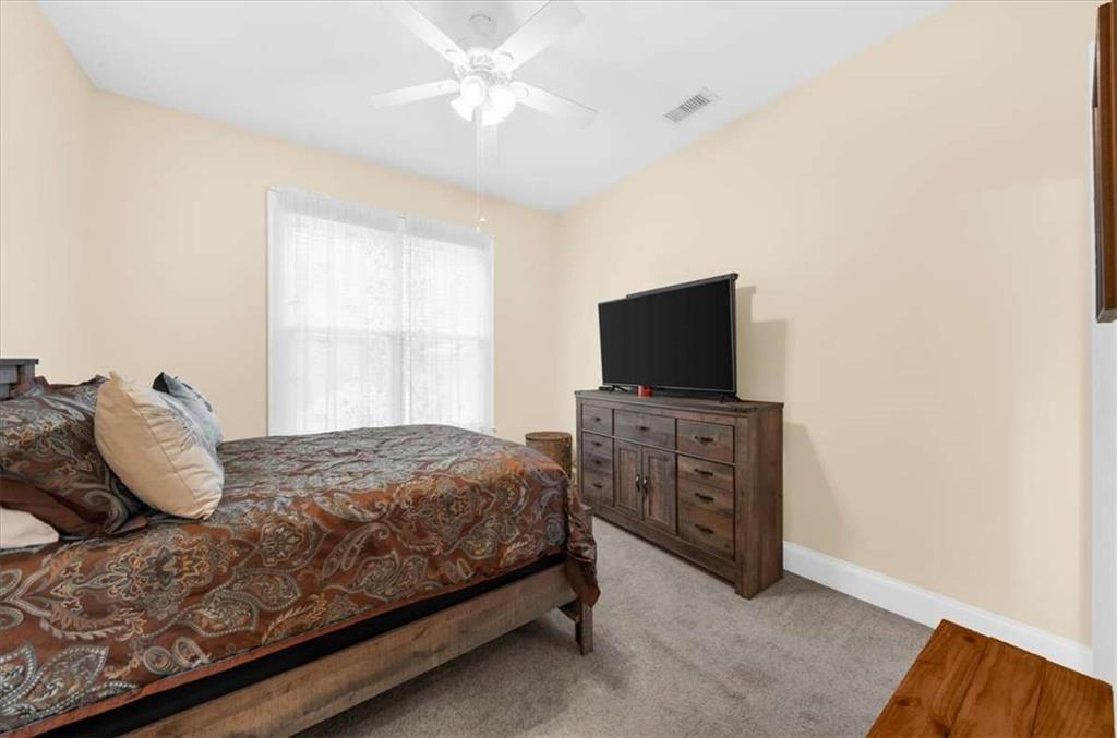 106 Westmore Road Southwest Rome, GA 30165 - Photo 34 of 56 a bedroom with a bed and a flat screen tv