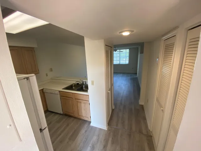a view of a kitchen from a hallway