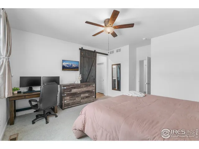 a bedroom with a workspace