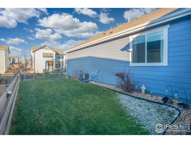 a view of a yard in front of a house with large tree