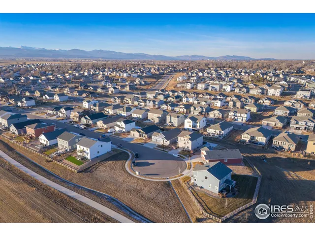 an aerial view of a residential houses with city view