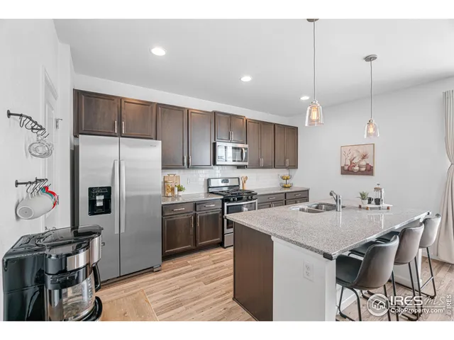 a kitchen with kitchen island a counter top space appliances and cabinets