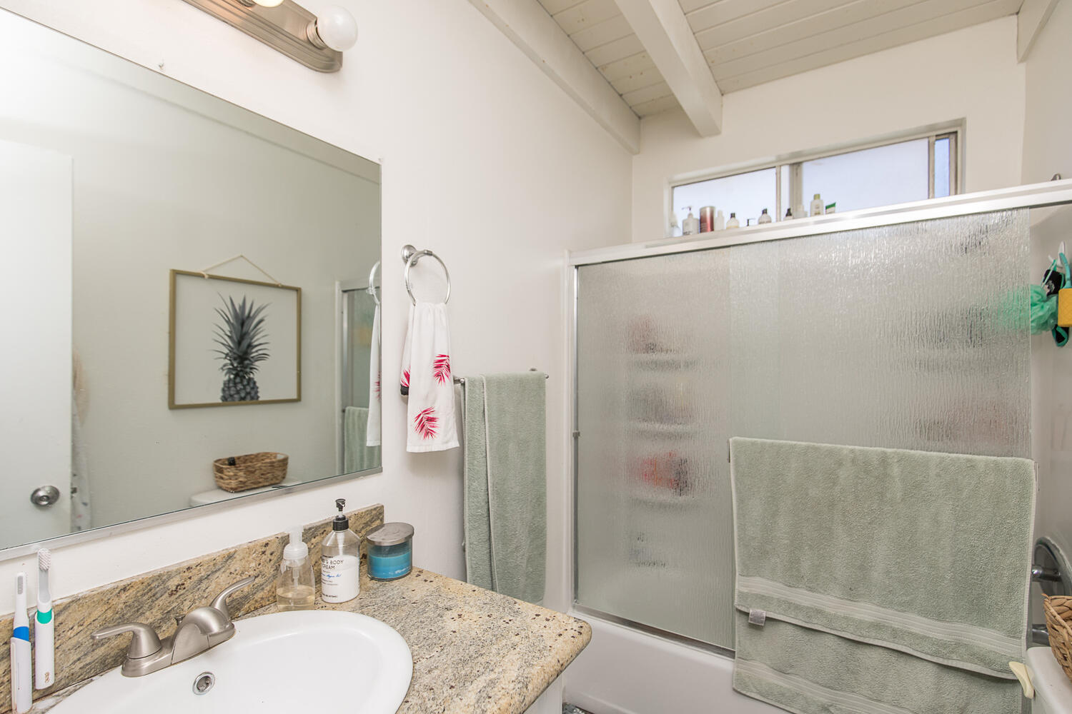 133 Burbank Avenue Oxnard, CA 93035 - Photo 13 of 40 a bathroom with a granite countertop tub sink and mirror