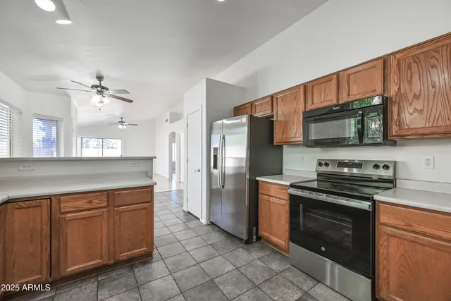 a kitchen with stainless steel appliances granite countertop a stove sink and cabinets