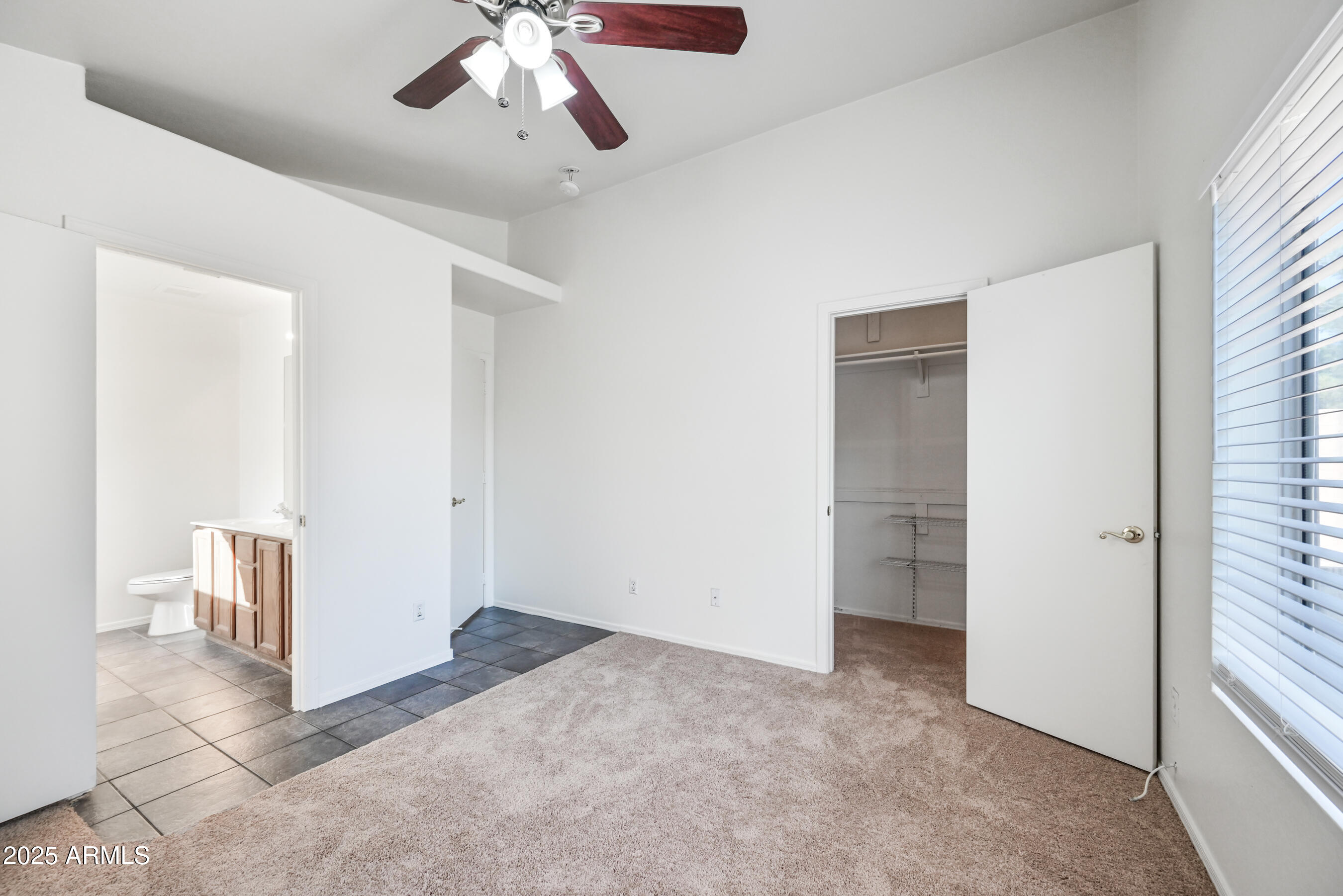 641 East Gail Drive Chandler, AZ 85225 - Photo 16 of 22 an empty room with a ceiling fan and carpet