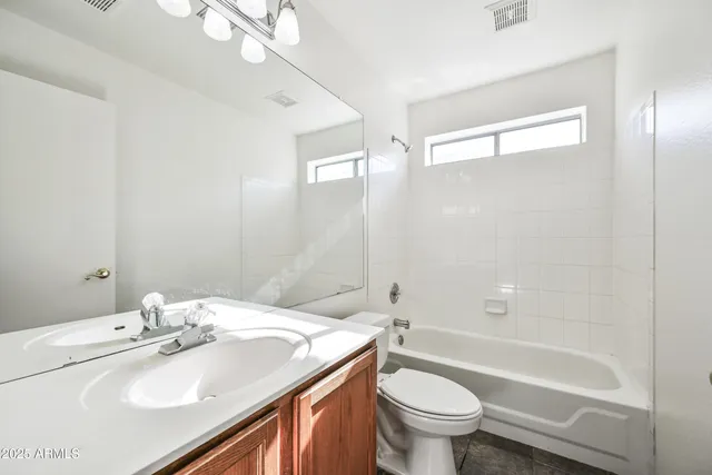 a bathroom with a sink toilet tub and shower