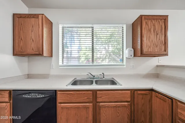 a kitchen with stainless steel appliances granite countertop a sink and a window