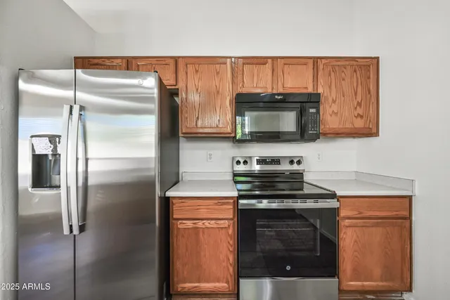 a kitchen with a refrigerator stove and microwave