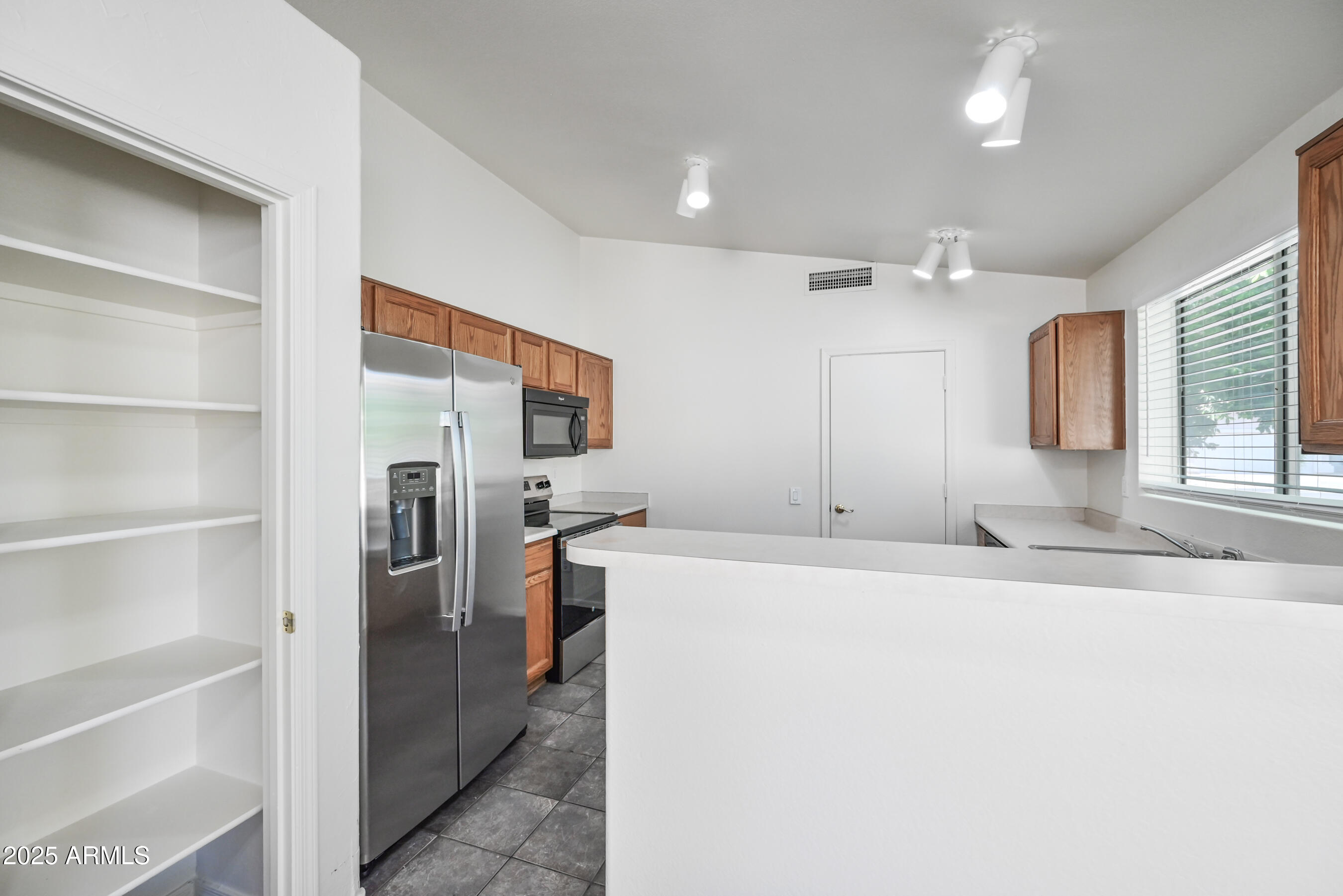 641 East Gail Drive Chandler, AZ 85225 - Photo 10 of 22 a large white kitchen with a refrigerator a stove a sink and a cabinets