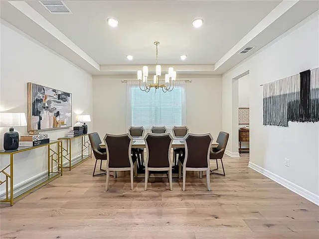 a hallway with a table and chairs