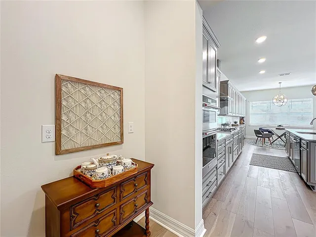 a living room with lots of furniture and a chandelier