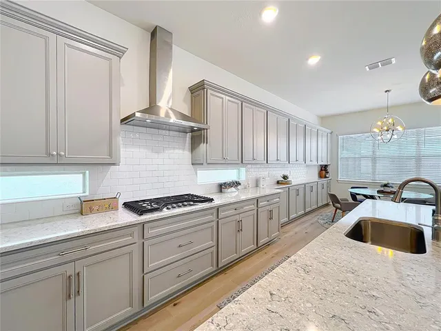 a living room with furniture kitchen view and a clock