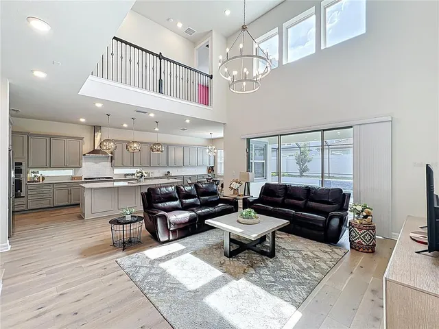 a kitchen with granite countertop a sink a stove cabinets and living room view
