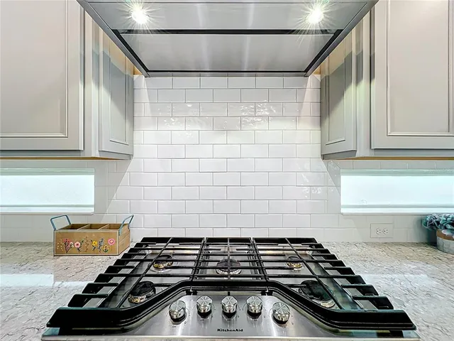 a kitchen with a dining table and chairs
