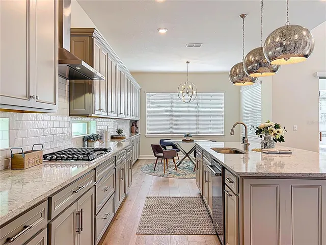 a view of a kitchen area with furniture and wooden floor
