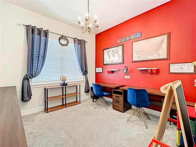 a view of staircase with a large window and a rug