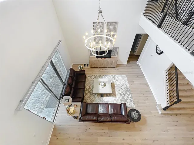 a spacious bedroom with a bed and a chandelier