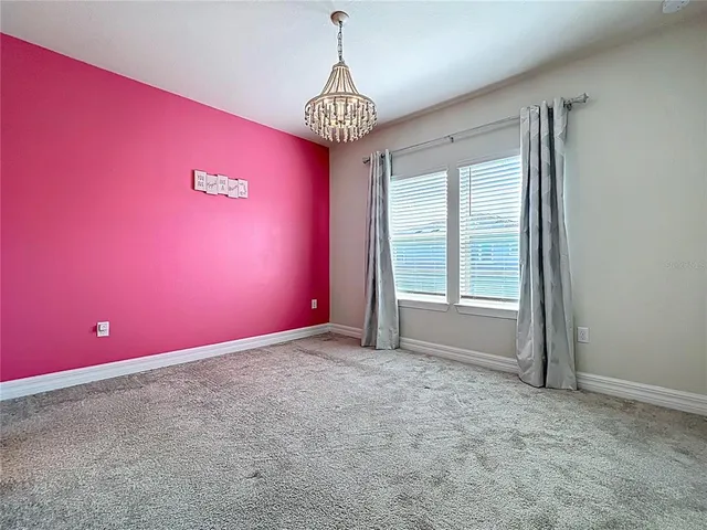 a spacious bathroom with a granite countertop sink toilet a mirror and shower