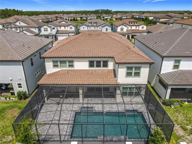an aerial view of residential houses with outdoor space and river