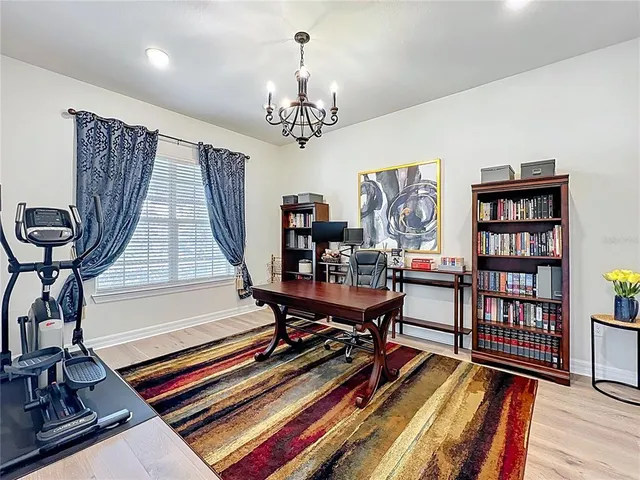 a view of a dining room with furniture and chandelier
