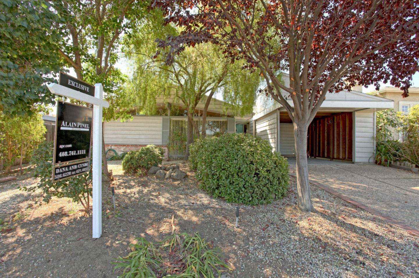 19100 Meiggs Lane Cupertino, CA 95014 - Photo 2 of 21 a front view of a house with a yard and tree