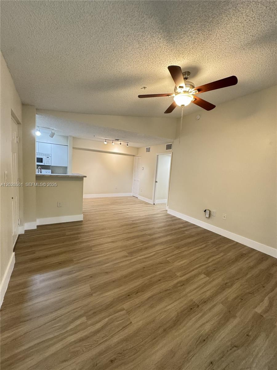 2021 Renaissance Boulevard, Unit 201 Miramar, FL 33025 - Photo 3 of 26 a view of a livingroom with wooden floor