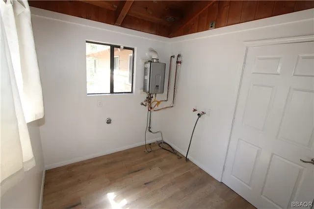 a view of a room with wooden floor and a window