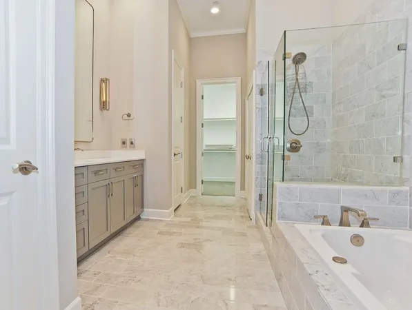 a spacious bathroom with a shower sink and mirror