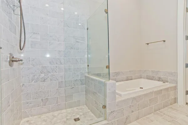 a bathroom with a bathtub and shower