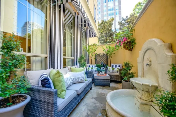 a living room filled with furniture and a potted plant