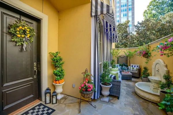a view of a porch with furniture and potted plants