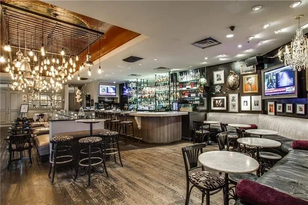 a living room with lots of furniture and a dining table with kitchen view