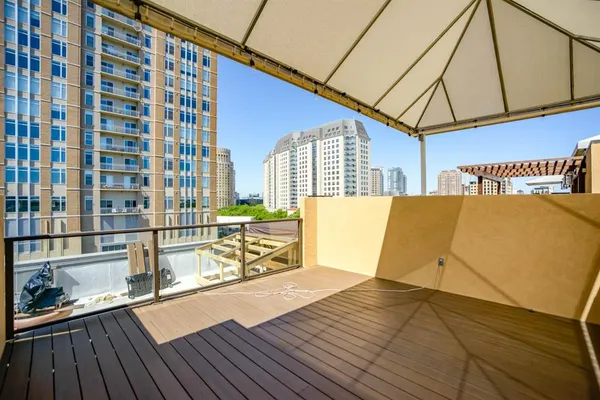 a view of a balcony with wooden floor