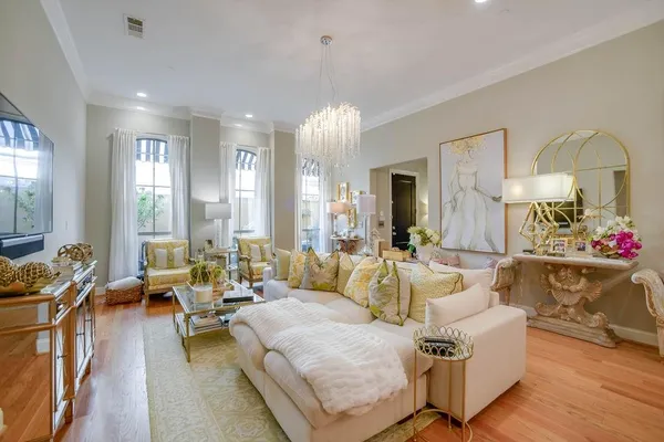 a living room with furniture and a chandelier